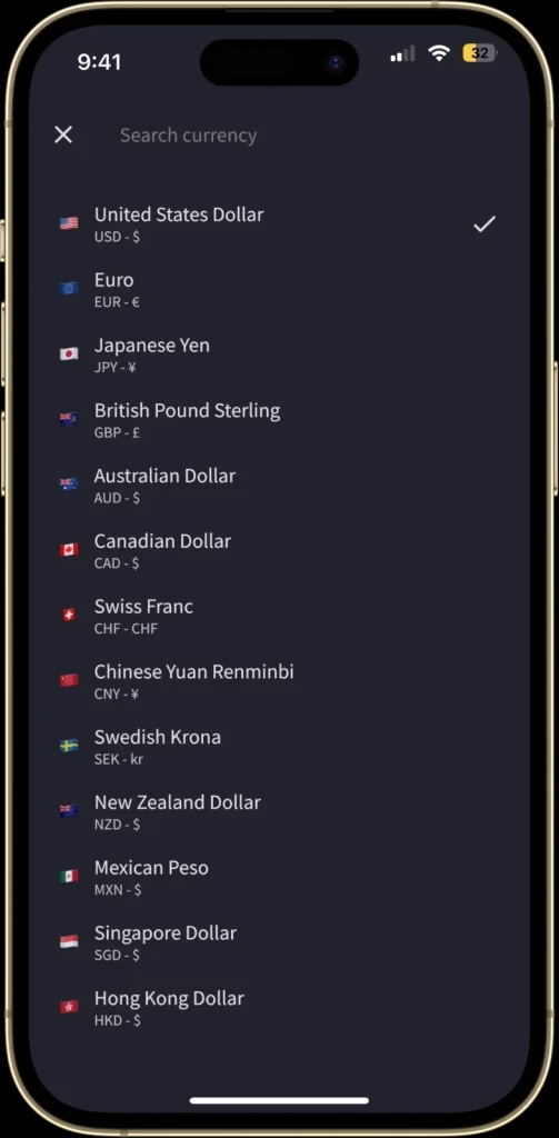 The "Currency Selection" screen is displayed, allowing users to choose from a list of over 150 currencies. Each currency is listed with its symbol and corresponding country flag.