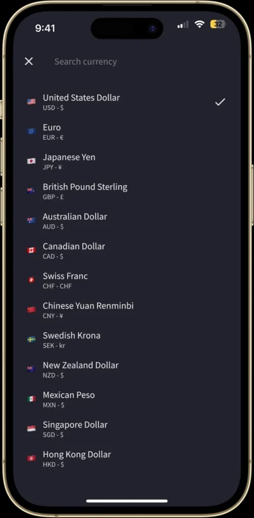 The "Currency Selection" screen is displayed, allowing users to choose from a list of over 150 currencies. Each currency is listed with its symbol and corresponding country flag.